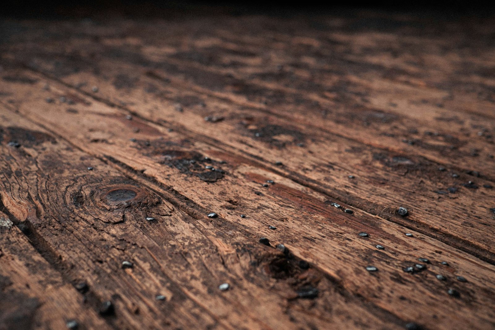 Removing old finishes and surface damage to reveal clean timber